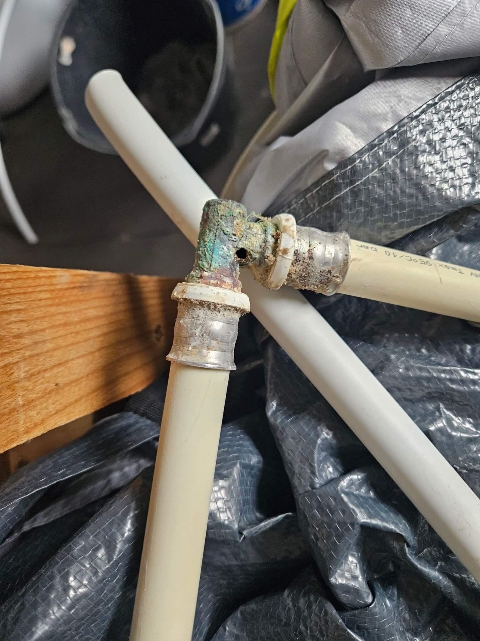 Uszkodzone i skorodowane połączenie instalacji wodnej z rurami PEX